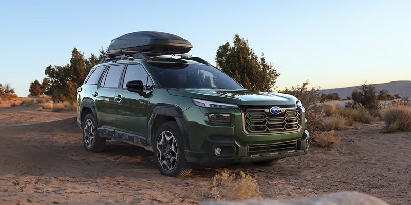 Green 2026 Subaru Outback with roof cargo outdoors